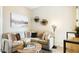 Cozy living room featuring a sectional sofa, round wood table and stylish decor at 37795 W Padilla St, Maricopa, AZ 85138