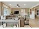 A spacious living room features a large leather sectional, ceiling fan, and neutral color palette at 37795 W Padilla St, Maricopa, AZ 85138