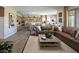 Well-designed living room offering an open layout, stylish furnishings, and seamless flow into the kitchen at 37795 W Padilla St, Maricopa, AZ 85138