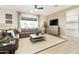 A comfortable living room showcases a sectional sofa, media console, and a ceiling fan at 37795 W Padilla St, Maricopa, AZ 85138