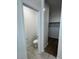 Powder room featuring a toilet, storage, and tile flooring at 38105 W Bello Ln, Maricopa, AZ 85138