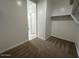 Walk-in closet with carpet flooring and ample storage space at 38105 W Bello Ln, Maricopa, AZ 85138