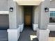 Inviting entryway with a covered porch, stylish light fixtures, and a view of the front door at 38105 W Bello Ln, Maricopa, AZ 85138