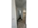 Hallway leading to a bedroom and laundry room, with tile flooring and modern interior doors at 38105 W Bello Ln, Maricopa, AZ 85138