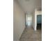 Bright hallway leading to open living space, with neutral tile flooring and natural light at 38105 W Bello Ln, Maricopa, AZ 85138