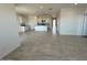 Spacious open-concept living space featuring tile flooring, recessed lighting, and a modern kitchen at 38105 W Bello Ln, Maricopa, AZ 85138