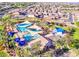 Aerial view of community pools showcasing ample seating, sun shades, and well-maintained recreational areas at 41448 N Eliana Dr, Queen Creek, AZ 85140