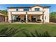 Backyard featuring a covered patio and a spacious grassy area perfect for outdoor activities at 41448 N Eliana Dr, Queen Creek, AZ 85140