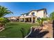 Expansive backyard featuring lush lawn, desert landscaping, and covered patio perfect for outdoor entertaining at 41448 N Eliana Dr, Queen Creek, AZ 85140