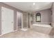 Bright bathroom featuring a glass-enclosed shower and a large soaking tub at 41448 N Eliana Dr, Queen Creek, AZ 85140