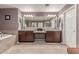 Bathroom featuring dual vanities, a large mirror, and a soaking tub at 41448 N Eliana Dr, Queen Creek, AZ 85140