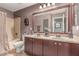 Bathroom featuring dual sinks, statues, and a shower-tub combo at 41448 N Eliana Dr, Queen Creek, AZ 85140