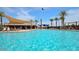 Large community pool features shaded lounging areas, poolside bar, and ample space for relaxation at 41448 N Eliana Dr, Queen Creek, AZ 85140