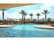 Resort-style community pool with palm trees, lounge chairs, and shaded cabanas at 41448 N Eliana Dr, Queen Creek, AZ 85140