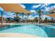 Inviting community pool area with clear water, lounge chairs, shaded areas, and poolside features at 41448 N Eliana Dr, Queen Creek, AZ 85140