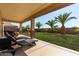 Relaxing covered patio offers shade and comfortable seating with views of the meticulously landscaped yard at 41448 N Eliana Dr, Queen Creek, AZ 85140
