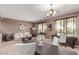 Bright dining area featuring a modern chandelier, neutral colors and a seamless connection to other spaces at 41448 N Eliana Dr, Queen Creek, AZ 85140