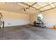 Clean and spacious garage featuring ample room for parking and an arched window offering natural light at 41448 N Eliana Dr, Queen Creek, AZ 85140
