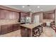 This kitchen features a large island with a sink and a stainless-steel refrigerator and microwave oven at 41448 N Eliana Dr, Queen Creek, AZ 85140