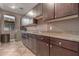 Functional laundry room features ample counter space, modern cabinetry, and a washing machine at 41448 N Eliana Dr, Queen Creek, AZ 85140