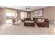 Comfortable living room with plush seating, ceiling fan and a sliding door to the outside patio at 41448 N Eliana Dr, Queen Creek, AZ 85140