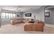 Bright living room with plush sectional sofa and large window at 41448 N Eliana Dr, Queen Creek, AZ 85140