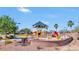 Bright and colorful community playground with slides, swings, and covered seating area at 41448 N Eliana Dr, Queen Creek, AZ 85140