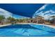 Community splash pad with fun water features, shaded seating, and nearby playground at 41448 N Eliana Dr, Queen Creek, AZ 85140