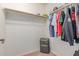 Spacious walk-in closet offers ample storage with shelving and hanging rods for organized living at 41448 N Eliana Dr, Queen Creek, AZ 85140