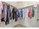 Walk-in closet with a variety of clothing hanging from a rod at 41448 N Eliana Dr, Queen Creek, AZ 85140