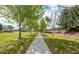Scenic community walking path lined with mature trees and lush green spaces for recreation at 41448 N Eliana Dr, Queen Creek, AZ 85140