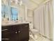 Well-lit bathroom with dark vanity, modern fixtures, and shower with curtain at 4615 E Navigator Ln, Phoenix, AZ 85050