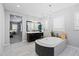 A luxurious bathroom features an elegant soaking tub and a vanity with a large mirror at 4615 E Navigator Ln, Phoenix, AZ 85050