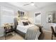 Stylish bedroom with a cozy bed, modern lighting, and a sleek black side table at 4615 E Navigator Ln, Phoenix, AZ 85050