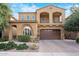 Inviting two-story home with a beautiful tan stucco exterior and a large two-car garage at 4615 E Navigator Ln, Phoenix, AZ 85050