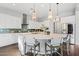 Bright kitchen with white cabinets, stainless steel appliances, and a large island with pendant lighting at 4615 E Navigator Ln, Phoenix, AZ 85050