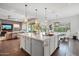 Spacious kitchen featuring a large central island with a sink, pendant lights, and ample cabinet space at 4615 E Navigator Ln, Phoenix, AZ 85050