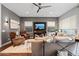 Comfortable living room with stylish decor, a large television, and natural light from the windows at 4615 E Navigator Ln, Phoenix, AZ 85050