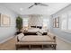 Spacious main bedroom with neutral tones, a ceiling fan, patterned wallpaper, and a four post bed at 4615 E Navigator Ln, Phoenix, AZ 85050