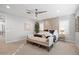 Bright main bedroom featuring a ceiling fan, patterned wallpaper, a four post bed, and a cushioned bench at 4615 E Navigator Ln, Phoenix, AZ 85050