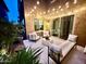 Inviting outdoor seating area with stylish furniture and ambient string lights at 4615 E Navigator Ln, Phoenix, AZ 85050