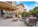 Backyard patio features a cozy fire pit, comfortable seating, and well-maintained landscaping at 4615 E Navigator Ln, Phoenix, AZ 85050