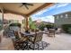 Spacious covered patio includes a dining area, lounge seating, and outdoor fan at 4615 E Navigator Ln, Phoenix, AZ 85050