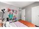 Cozy bedroom with playful decor, closet, and doorway to another room at 5302 W Poinsettia Dr, Glendale, AZ 85304