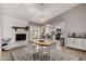 Comfortable dining area with a fireplace, backyard access, and an open view of the kitchen at 5302 W Poinsettia Dr, Glendale, AZ 85304