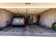 Organized two-car garage featuring a parked SUV and storage shelves at 5302 W Poinsettia Dr, Glendale, AZ 85304