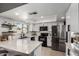 Bright kitchen featuring stainless steel appliances, white cabinetry, subway tile backsplash, and a large island at 5302 W Poinsettia Dr, Glendale, AZ 85304