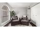 Inviting living room with arched window, cozy chairs, and a plant at 5302 W Poinsettia Dr, Glendale, AZ 85304
