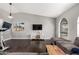 Open living room with wood floors, vaulted ceilings, and plenty of natural light at 5302 W Poinsettia Dr, Glendale, AZ 85304