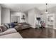 Cozy living room with a sectional couch, wood floors, and grey walls at 5302 W Poinsettia Dr, Glendale, AZ 85304